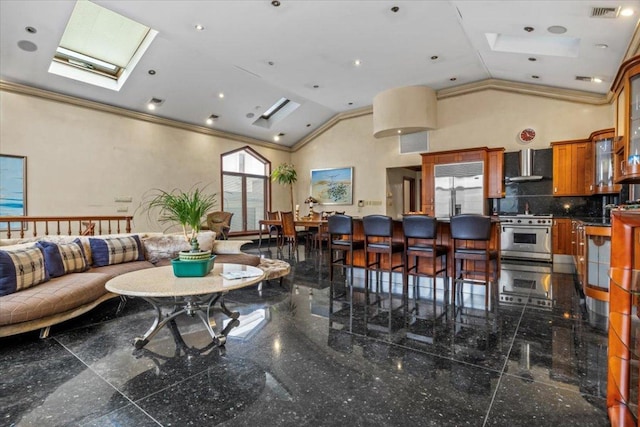 interior space featuring crown molding, high vaulted ceiling, and a skylight