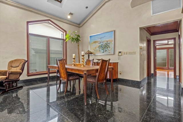 dining room with crown molding and a towering ceiling