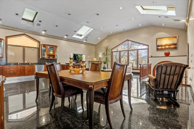 dining area with a skylight and high vaulted ceiling