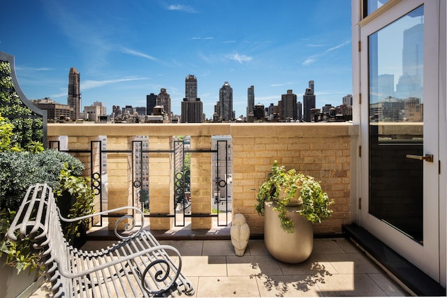 view of patio with a balcony and a city view