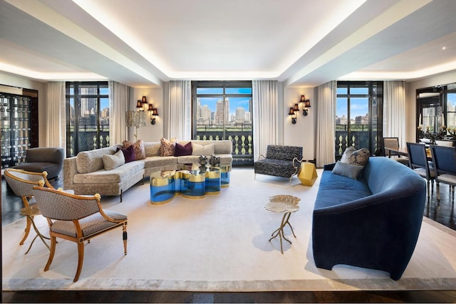 living room featuring a wall of windows and a raised ceiling