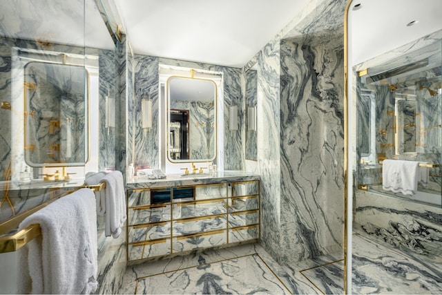 825 5th Ave Unit 15Flr, New York City, NY 10065 - bathroom featuring marble tiled flooring, a marble finish shower, and vanity