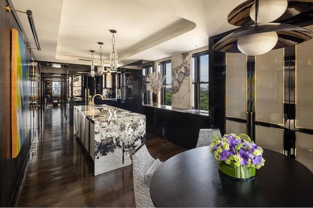 825 5th Ave Unit 15Flr, New York City, NY 10065 - dining space featuring a raised ceiling, dark wood-style floors, and a chandelier