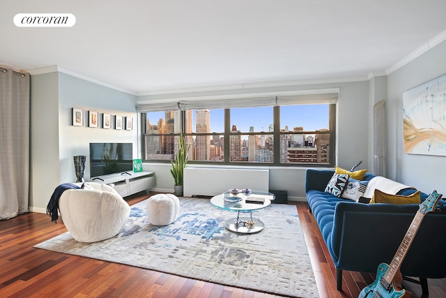 living room featuring visible vents, crown molding, baseboards, and wood finished floors