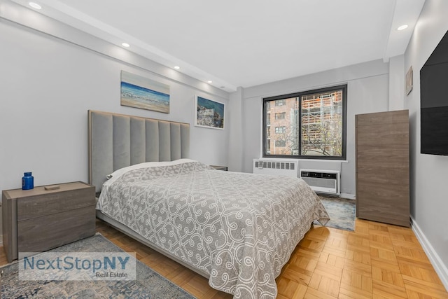 bedroom featuring a wall mounted air conditioner, baseboards, radiator, and recessed lighting