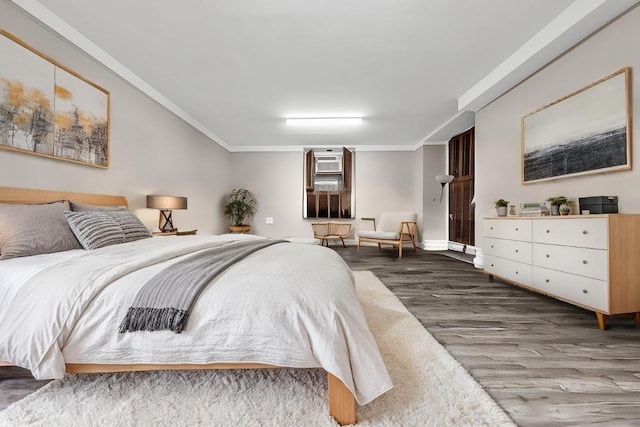 bedroom with crown molding and dark hardwood / wood-style floors