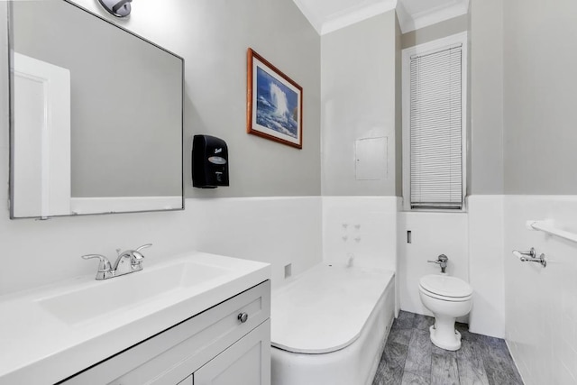 bathroom with vanity, tile walls, crown molding, and toilet