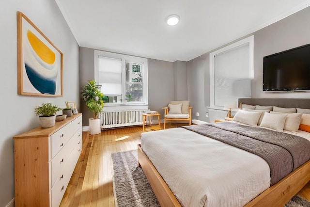 bedroom featuring light hardwood / wood-style flooring and radiator heating unit