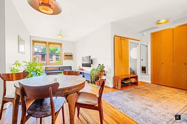 dining area featuring light wood-style flooring and baseboards