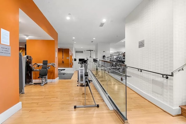 workout area featuring light wood-type flooring