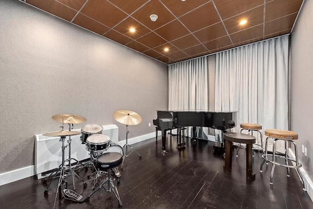 miscellaneous room with dark hardwood / wood-style floors and a drop ceiling