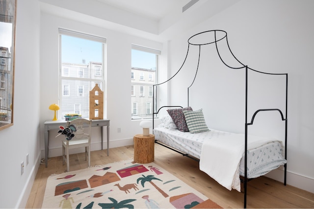 bedroom with wood finished floors and baseboards