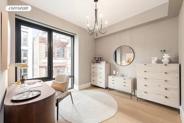 living area featuring an inviting chandelier, french doors, and light wood-type flooring