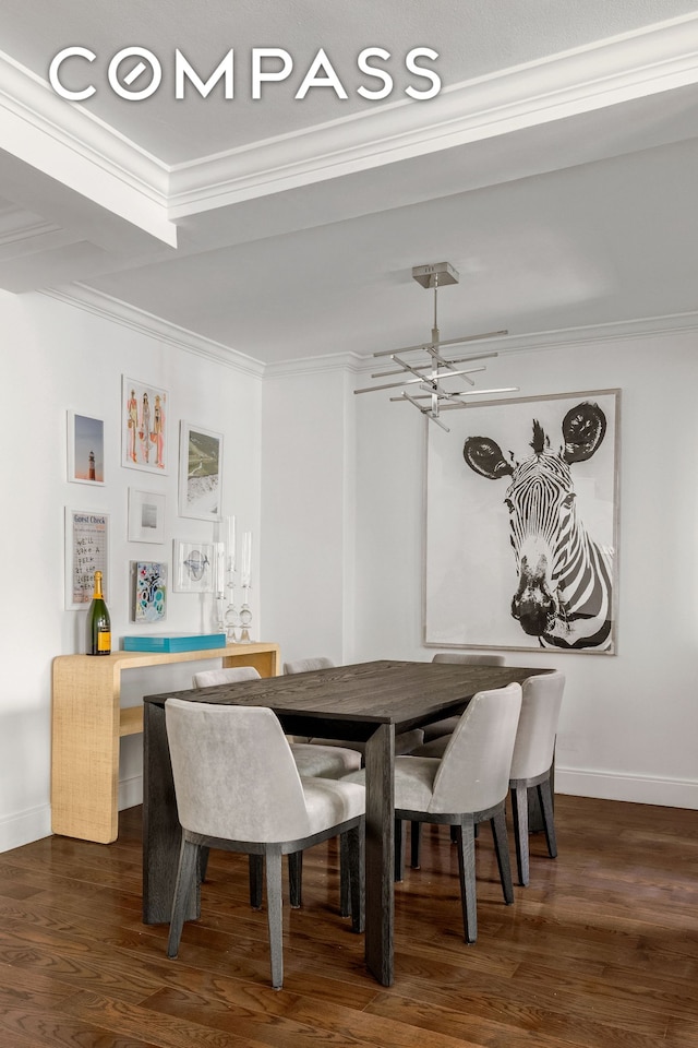 dining area featuring dark wood-style floors, crown molding, and baseboards