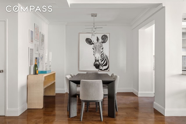 dining area featuring baseboards, ornamental molding, and wood finished floors