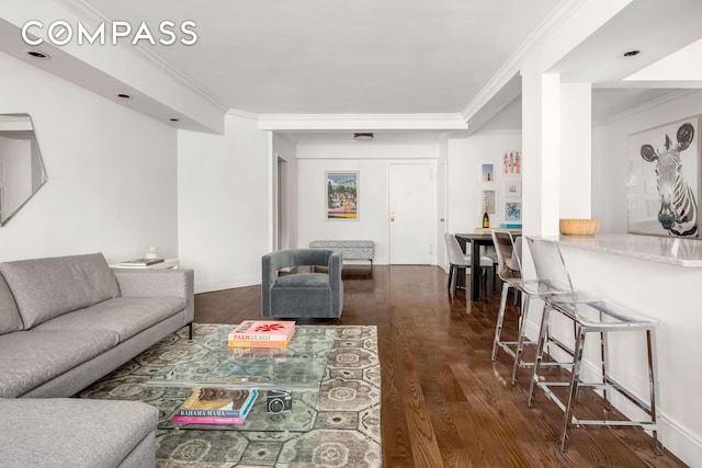 living room with crown molding and dark wood-type flooring
