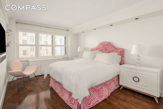 bedroom with dark wood-style flooring and ornamental molding