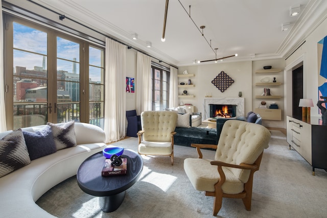 living area featuring built in shelves, french doors, and ornamental molding