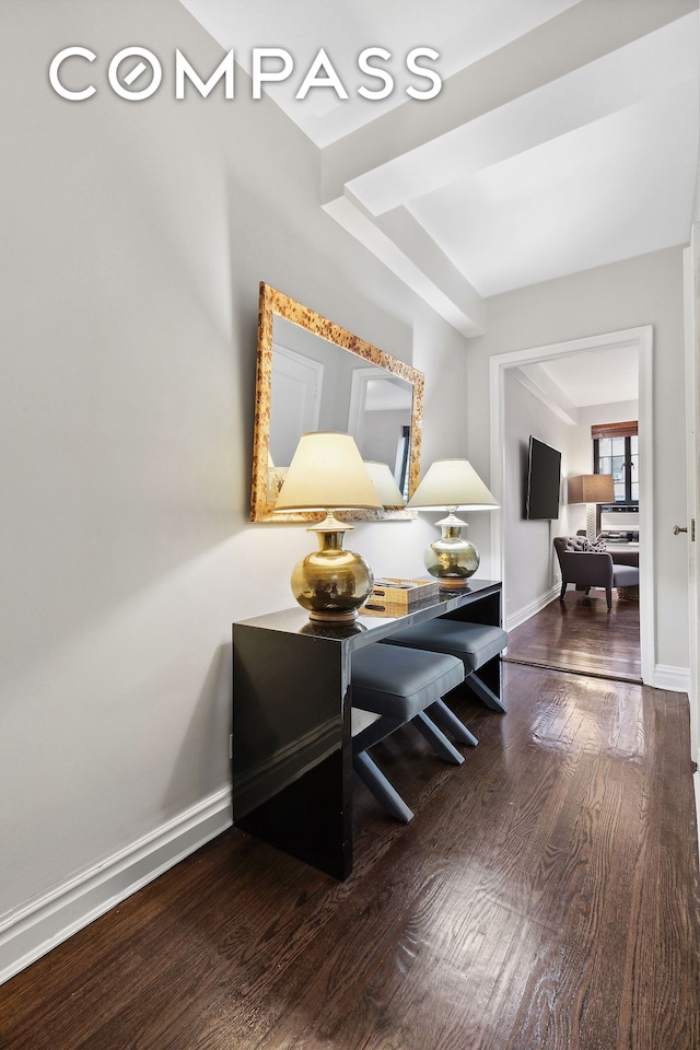 interior space featuring wood finished floors and baseboards