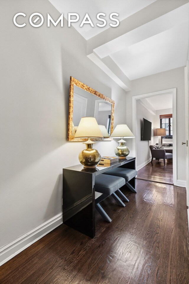 interior space with baseboards and wood finished floors