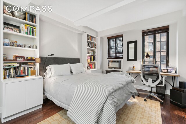 bedroom featuring baseboards and wood finished floors