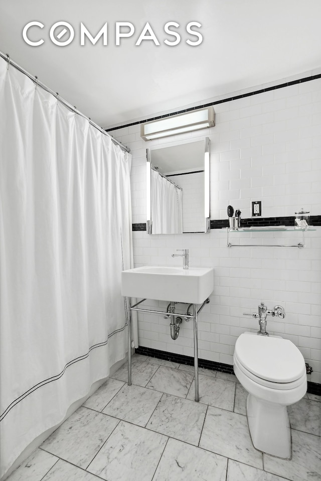 full bathroom with curtained shower, marble finish floor, tile walls, and toilet