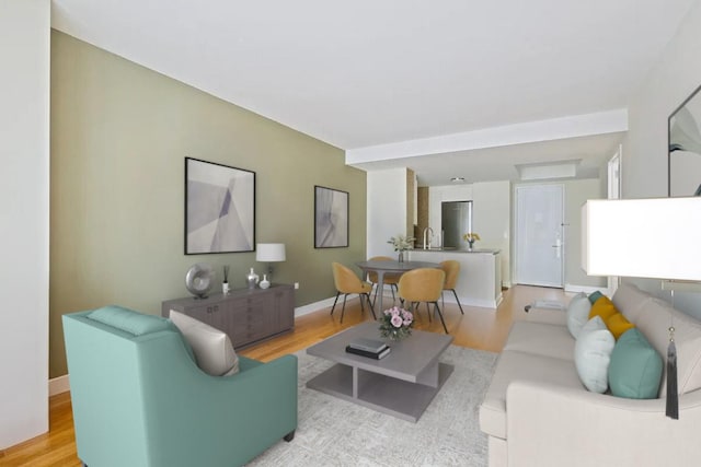 living room with light wood-style floors and baseboards