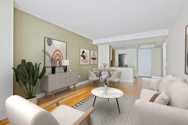 living room with light wood finished floors and baseboards