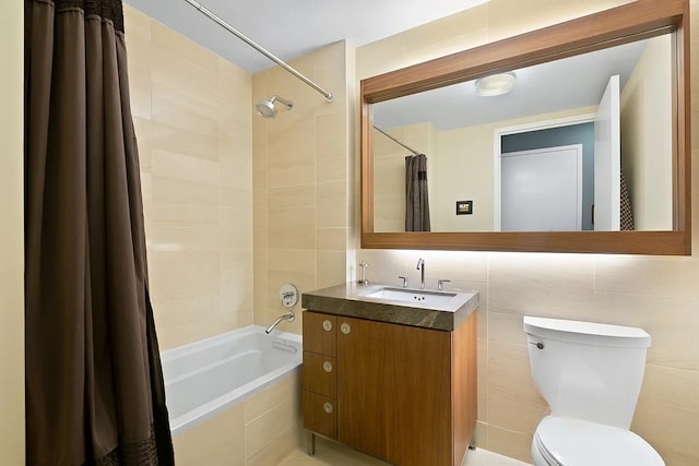 bathroom with vanity, decorative backsplash, tiled shower / bath combo, tile walls, and toilet