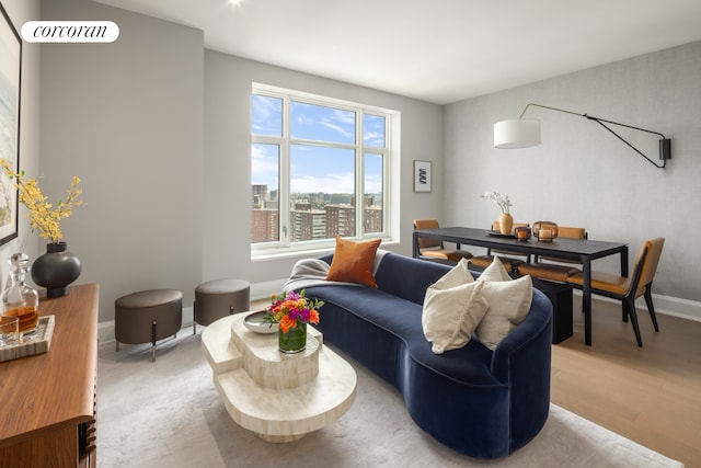 living area featuring light wood-type flooring and baseboards