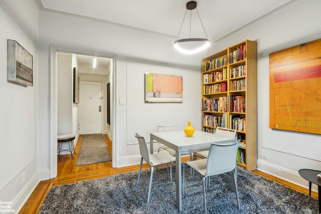 dining room featuring baseboards and wood finished floors