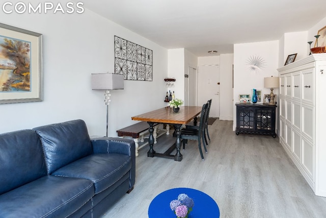 dining space with light wood-type flooring