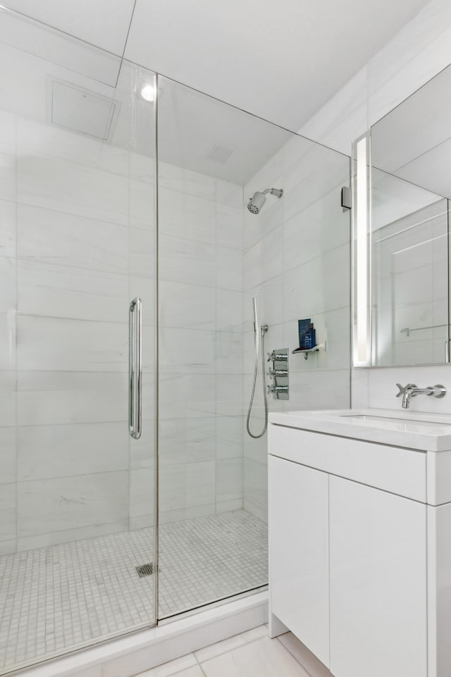 bathroom featuring vanity and a shower stall