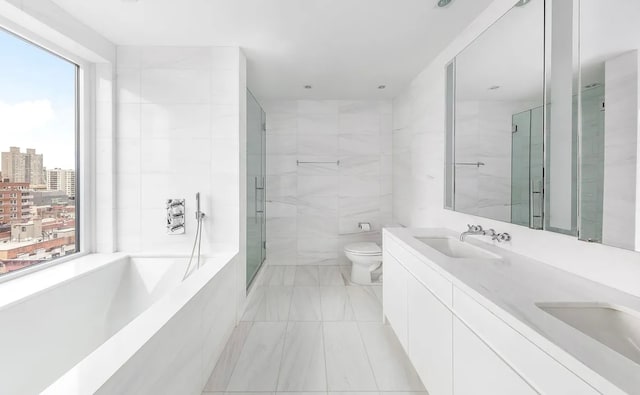 bathroom with a healthy amount of sunlight, a sink, a bath, and a city view