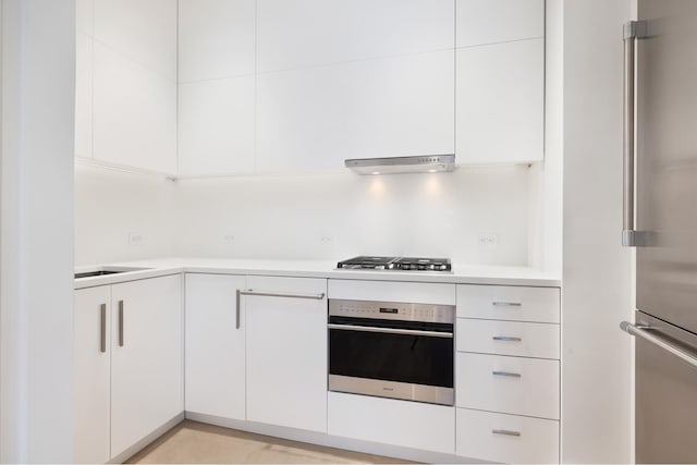 kitchen featuring stainless steel appliances, light countertops, white cabinets, and under cabinet range hood