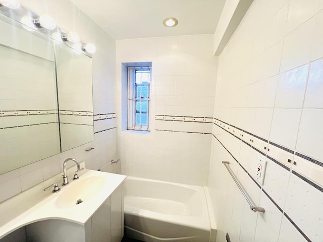 bathroom with tile walls, sink, and a tub