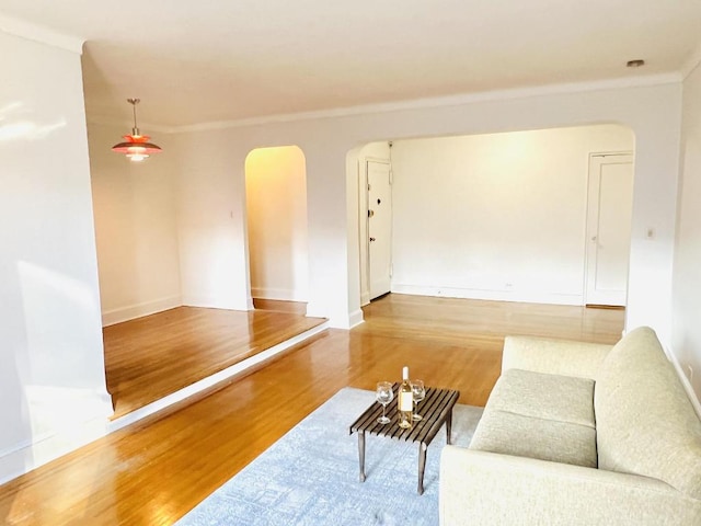 living room featuring hardwood / wood-style flooring and crown molding