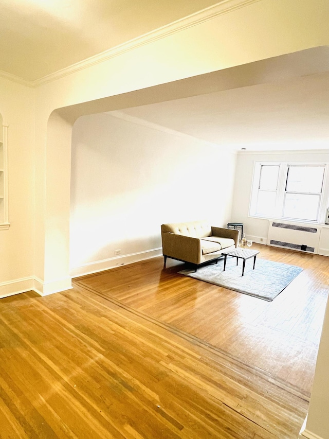 76-15 35th Ave Unit 5-H, New York City, NY 11372 - unfurnished room featuring crown molding, radiator, baseboards, and wood finished floors