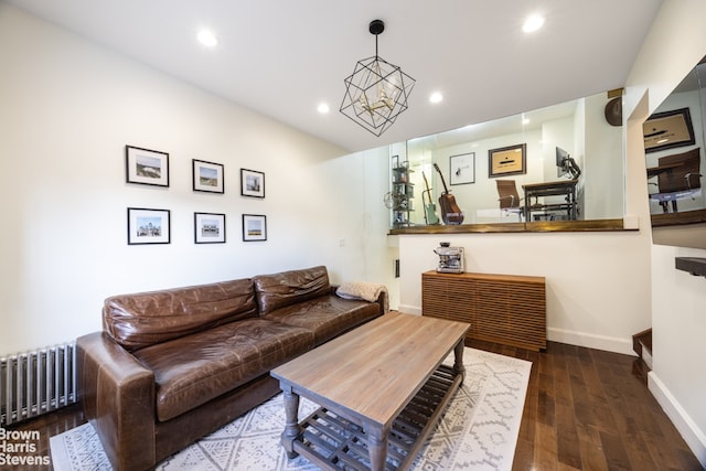 living room featuring an inviting chandelier, dark hardwood / wood-style floors, and radiator heating unit