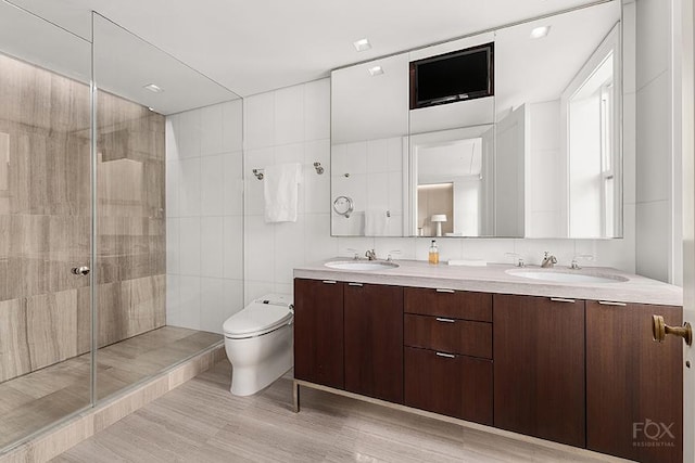 50 E 77th St Unit 11B, New York City, NY 10075 - full bathroom with a shower stall, toilet, double vanity, and wood finished floors