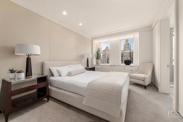 bedroom with a view of city and light colored carpet