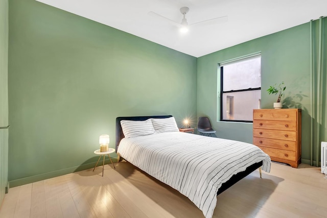 130 W 16th St Unit 51, New York City, NY 10011 - bedroom featuring wood finished floors, a ceiling fan, and baseboards