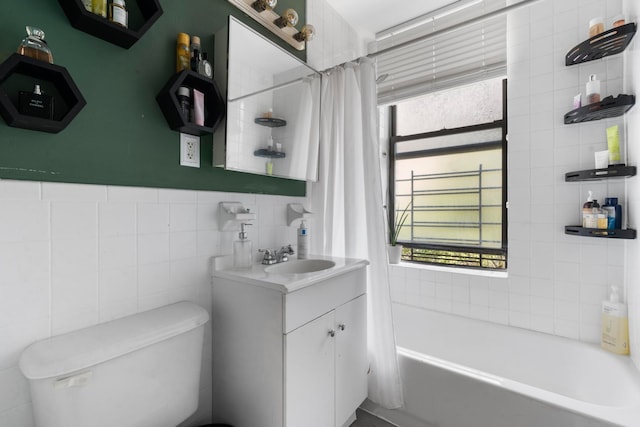 bathroom featuring toilet, plenty of natural light, tile walls, and vanity