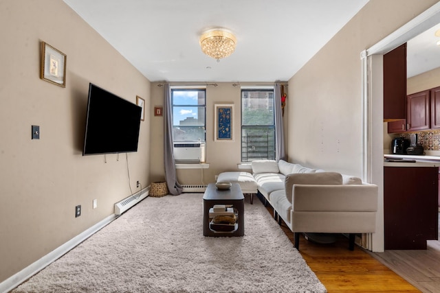 living room featuring a baseboard heating unit, cooling unit, and baseboards