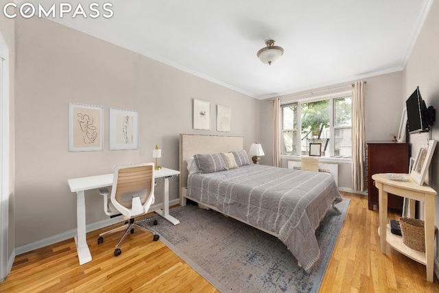 bedroom featuring hardwood / wood-style floors and ornamental molding