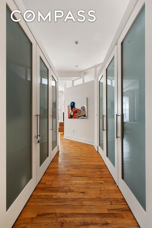 126 W 22nd St Unit 5N, New York City, NY 10011 - corridor featuring french doors, wood finished floors, and healthy amount of natural light