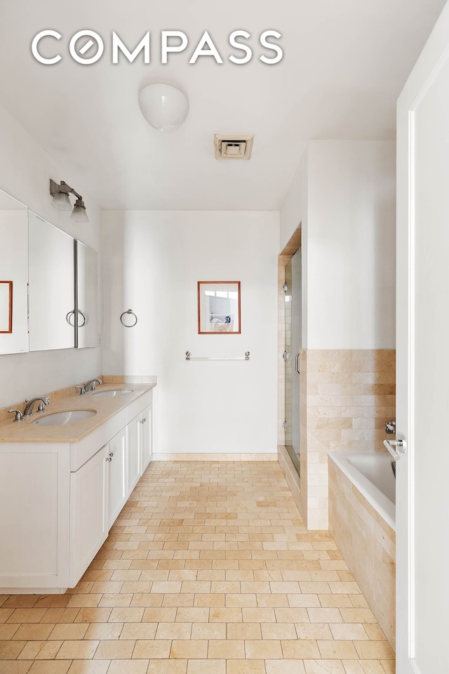 126 W 22nd St Unit 5N, New York City, NY 10011 - full bathroom featuring a garden tub, double vanity, and a stall shower
