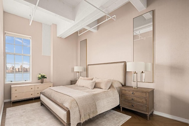 bedroom with parquet floors and a water view