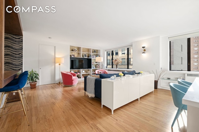 30 W 61st St Unit 9C, New York City, NY 10023 - living area featuring light wood-style floors and built in shelves
