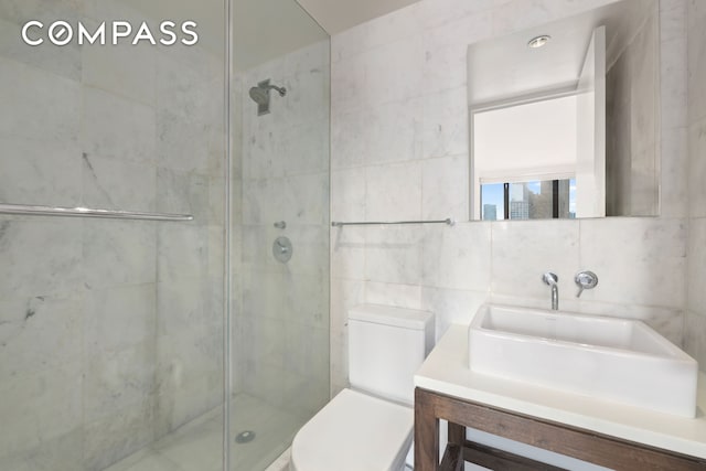 30 W 61st St Unit 9C, New York City, NY 10023 - full bath featuring tile walls, a shower stall, toilet, and vanity